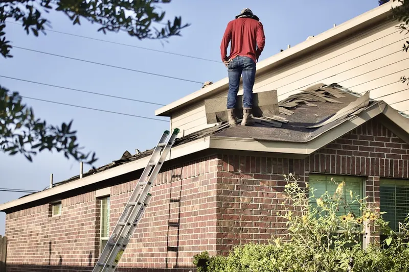 Professional roofer working on a residential roof in Seneca Chase